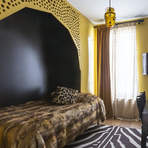 Unwind in the bohemian style bedroom with its faux furs