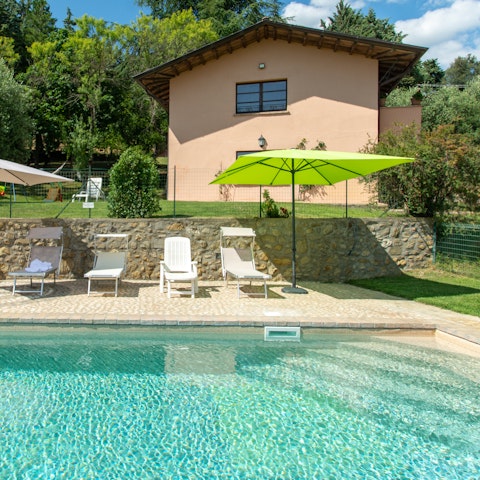 Stretch out by the shared swimming pool