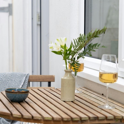 Enjoy a glass of wine and a few nibbles on the small patio