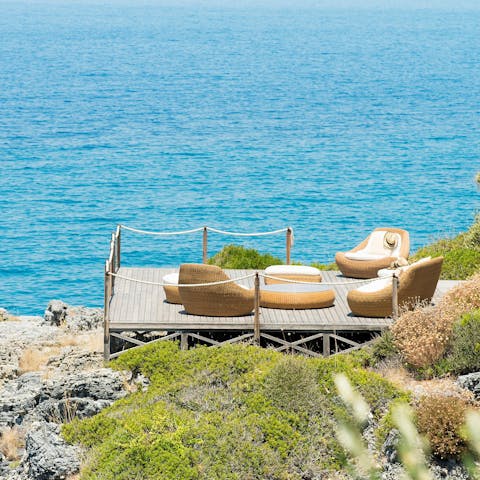 Gather in the outdoor lounge on the edge of the water for a few cocktails