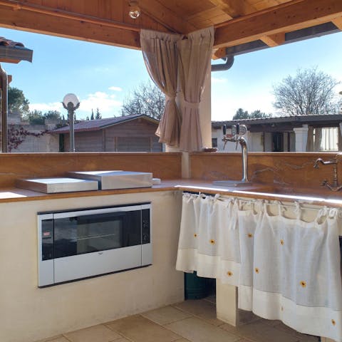 Whip up a culinary masterpiece for everyone to enjoy in the outdoor kitchen