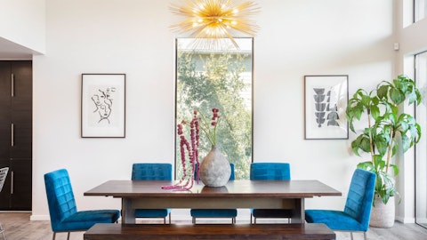 Gather under a statement chandelier for long, lively dinners