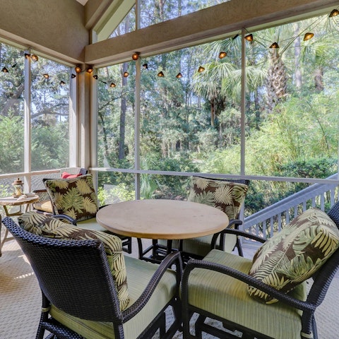 Gather for drinks and games on the screened porch