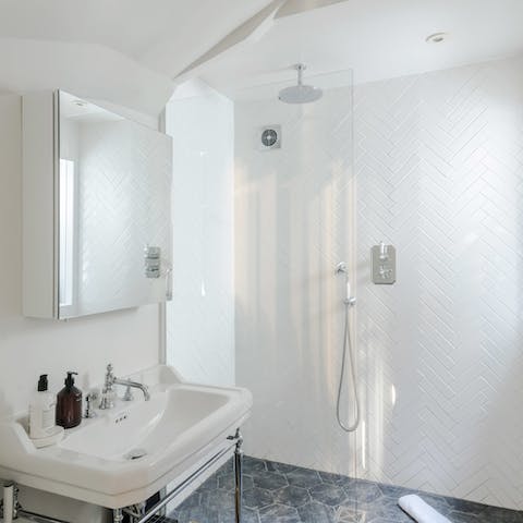 Pamper yourself in the sleek bathroom with its rainfall shower
