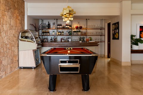 Grab a drink from the bar before playing a game of pool